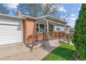 Front of the house showing a brick facade, a covered porch, and a well-kept lawn at 6882 Moore St, Arvada, CO 80004