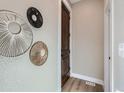 Bright hallway with modern wall decor and a wooden door at 3120 N Race St, Denver, CO 80205