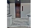 Inviting covered front porch with gray tile flooring and painted brick columns at 3120 N Race St, Denver, CO 80205