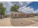 Charming brick home with a well-kept front yard and detached garage at 6991 Warren Dr, Denver, CO 80221
