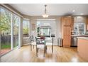 Charming dining area with a glass table and natural light from the sliding glass doors at 13078 Monaco Way, Thornton, CO 80602