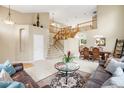 Open entryway with a staircase, dining area, and comfortable living space at 13078 Monaco Way, Thornton, CO 80602