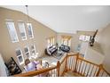 Open-concept living space featuring a living room, dining area, and ample natural light from large windows at 13078 Monaco Way, Thornton, CO 80602
