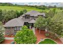 The home features amazing curb appeal, mature trees, and is located on a golf course at 4586 Carefree Trl, Parker, CO 80134