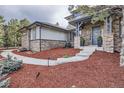 Beautiful home with stone facade and a well-maintained front yard and walkway at 4586 Carefree Trl, Parker, CO 80134