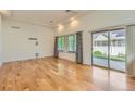 Spacious living room featuring hardwood floors, natural light, and sliding glass doors leading to the outdoors at 19753 E 54Th Ave, Denver, CO 80249