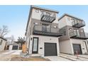 Contemporary three-story home featuring two balconies, light siding, and a one-car garage at 2162 S Ash St, Denver, CO 80222