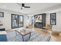 Well-lit living space with a modern fireplace, hardwood flooring, and access to an outdoor balcony at 2162 S Ash St, Denver, CO 80222