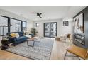 Bright living room with hardwood floors, modern fireplace, and sliding glass doors to a balcony at 2162 S Ash St, Denver, CO 80222