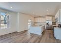 Modern kitchen featuring stainless steel appliances and a large island with sink at 738 N Clubview St, Watkins, CO 80137