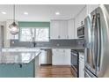 Well-lit kitchen featuring an island, stainless appliances, and granite counters, perfect for modern living at 11886 W 107Th Ave, Westminster, CO 80021