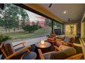 Relaxing outdoor living space with seating, fire pit, and scenic views of the forest at 9228 Lone Timber Ct, Parker, CO 80134