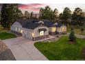 Stunning home with a three-car garage, beautiful landscaping, and a long driveway at 9228 Lone Timber Ct, Parker, CO 80134