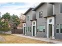 Modern townhomes feature gray stucco exteriors with white trim and dark green doors at 5810 W 39Th Pl, Wheat Ridge, CO 80212
