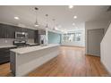 Modern kitchen with a large island, stainless steel appliances, and ample natural light at 5810 W 39Th Pl, Wheat Ridge, CO 80212