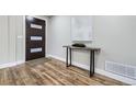 Light and airy entryway with hardwood floors and modern console table at 7076 S Newland St, Littleton, CO 80128
