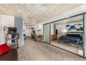 Open concept living space with concrete ceilings adjacent to the modern bedroom at 1020 15Th St # 17K, Denver, CO 80202