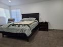 Bedroom with big windows, dark furnishings, soft carpet, and comfy bedding at 9133 W Cedar Dr # A, Lakewood, CO 80226