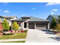 Attractive single-story home showcases stone details, a well-kept lawn, and an expansive driveway to the three-car garage at 7814 S Grand Baker Ct, Aurora, CO 80016