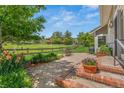 Private backyard featuring a large, stone patio and expansive lawn at 10 Oakmont Ln, Littleton, CO 80127