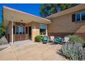 Inviting front patio featuring comfortable seating, perfect for relaxing outdoors at this charming brick home at 1497 S Garfield St, Denver, CO 80210