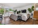Bright and airy living room with hardwood floors, stylish furniture, and large windows offering natural light at 1497 S Garfield St, Denver, CO 80210