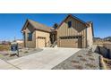 Exterior of a two story house with an attached garage, featuring a well maintained front yard at 5134 Cupule Trl, Castle Rock, CO 80104