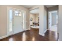 Bright foyer with hardwood floors leads to a living space with a white door at 5134 Cupule Trl, Castle Rock, CO 80104