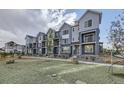 Row of new townhouses with gray siding and landscaping at 2370 W 167Th Ln, Broomfield, CO 80023