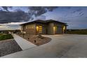 Modern home exterior featuring a two-car garage, sleek design, and manicured landscaping at 8868 Geyser Peak Way, Parker, CO 80138