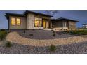 Beautiful home exterior with stone accents, modern windows, and attractive landscaping at 8868 Geyser Peak Way, Parker, CO 80138