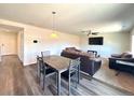 Comfortable living room area featuring hardwood floors, recessed lights, and neutral walls at 47373 Lily Ave, Bennett, CO 80102
