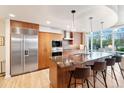Gourmet kitchen with granite countertops, stainless steel appliances, and a breakfast bar seating four at 1690 Bassett St # 6, Denver, CO 80202