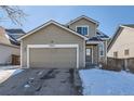 Two-story house with attached garage and snow-covered front yard at 20942 E 40Th Pl, Denver, CO 80249