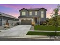 Beautiful two-story home featuring a well-manicured lawn, a two car garage, and lovely landscaping at 16268 Mount Silverheels Way, Broomfield, CO 80023