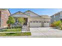 Single-Gathering home with a well-maintained lawn and an attached three-car garage at 24447 E Ada Ave, Aurora, CO 80018