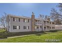 Traditional-style condo building with exterior balconies and a well-maintained lawn at 14493 E Jewell Ave # 102, Aurora, CO 80012