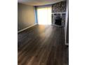 Bright living room with wood-look floors, stone fireplace, and sliding glass doors at 14493 E Jewell Ave # 102, Aurora, CO 80012