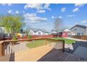 Large backyard with a wooden deck, mature trees, shed and play area, perfect for outdoor entertaining at 765 Freestone St, Brighton, CO 80603