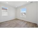 Bright bedroom with wood flooring and large windows offering plenty of natural light at 1306 Sienna Peak Cir, Erie, CO 80516