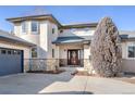 Front entrance of a large, well-kept home with a dark wood front door at 4405 Fairway Ln, Broomfield, CO 80023