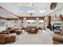 Bright living room with large windows, cozy fireplace, and comfortable seating arrangement at 4405 Fairway Ln, Broomfield, CO 80023