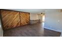 Spacious living room featuring wood-look flooring and a custom wood accent wall at 2741 W 134Th Cir, Broomfield, CO 80020