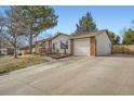 Well-maintained single-story home with an attached garage and a spacious driveway at 6233 W 75Th Ave, Arvada, CO 80003
