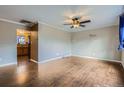 Bright living room featuring new hardwood flooring and a modern ceiling fan at 6233 W 75Th Ave, Arvada, CO 80003