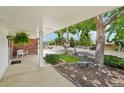 Covered front porch shows white bench, greenery, and a mature shade tree at 841 Beech St, Golden, CO 80401