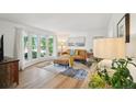 Bright living room with large windows, hardwood floors, and comfortable furnishings at 841 Beech St, Golden, CO 80401