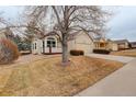 Street view of a charming single-story home with a two-car garage, a cozy front porch, and mature trees at 6522 S Hoyt Way, Littleton, CO 80123