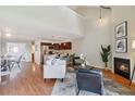 Bright and inviting living room features a cozy fireplace and open floor plan at 10550 W Jewell Ave # 301, Lakewood, CO 80232