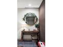 Inviting entryway with round mirror, wood table, lamp, and stylish rug, creating a warm welcome at 3420 W 32Nd Ave # 203, Denver, CO 80211
